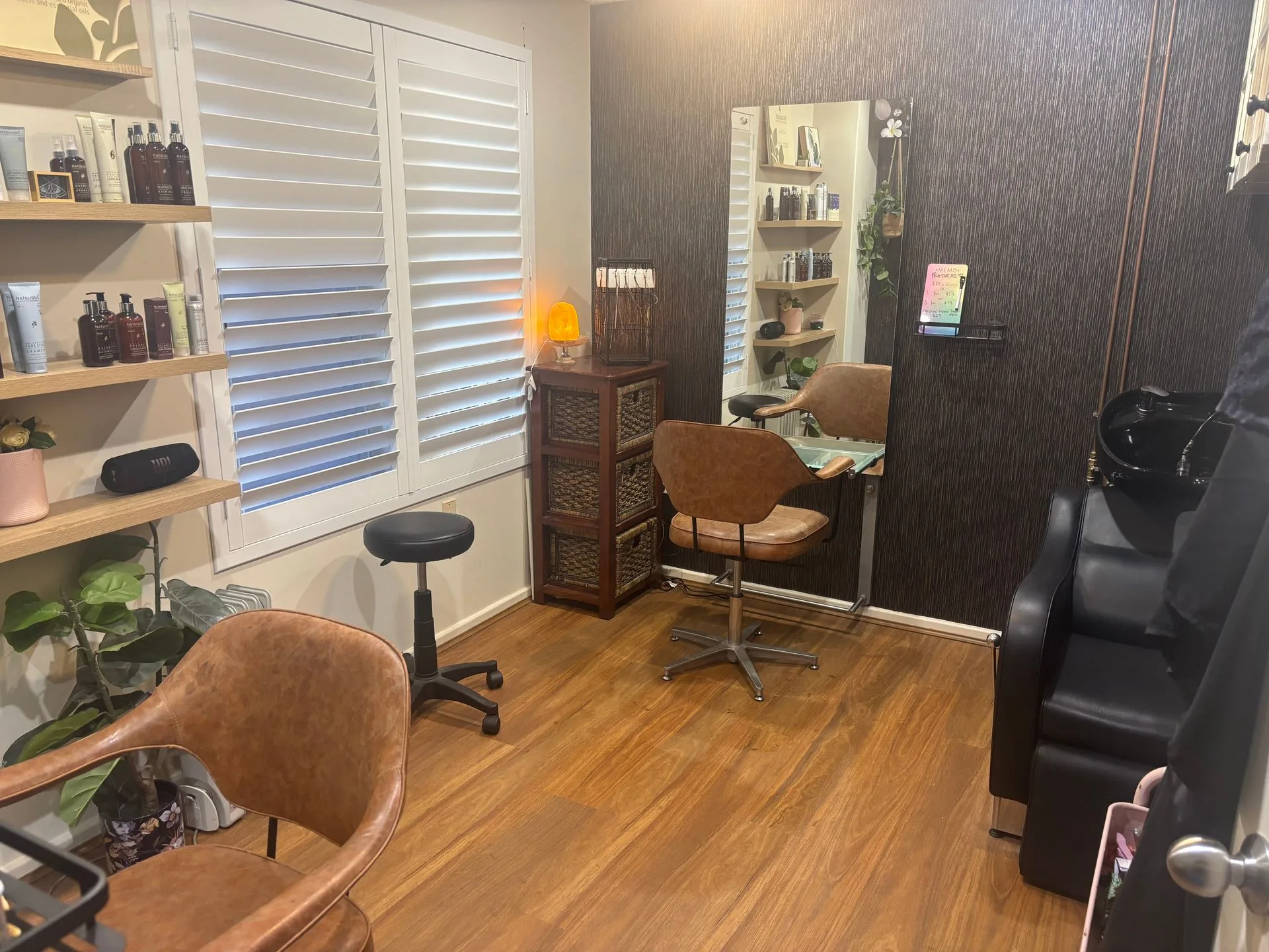 Interior of Holistic Hair, a private organic hair salon in Ferndale Perth, with styling chair, mirror and NATULIQUE product shelves